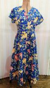 Cotton summer dress with daffodils and primroses printed on a blue ground, labelled 'Thomas and