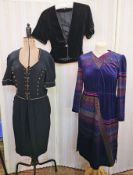 A navy cocktail dress with laced tie front with navy and gilt buttons and narrow gilt braid detail