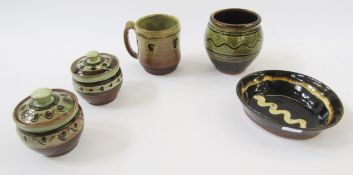 Two Sidney Tustin olive green and brown slip trail decorated preserve/mustard pots, 10.5cm high