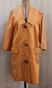Vintage 1970's orange leather coat, three-button metal fastening, pockets and a shawl collar, and
