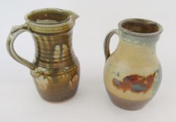 Two Ray Finch (1914-2012) for Winchcombe jugs, one slight baluster shape with mottled olive glaze,