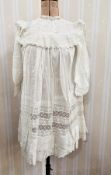 A child's Edwardian nightgown with embroidered frilled collar to the bodice, embroidered flounces