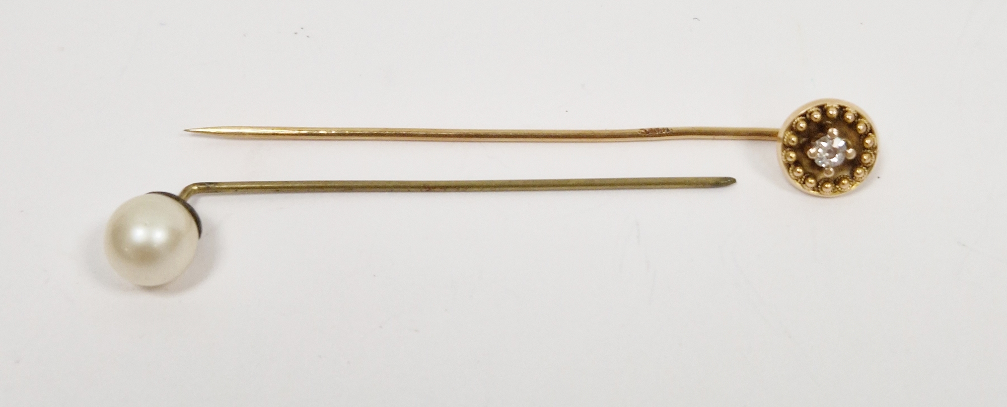 Victorian gold stickpin set with a central diamond within wirework and bead mount, unmarked,
