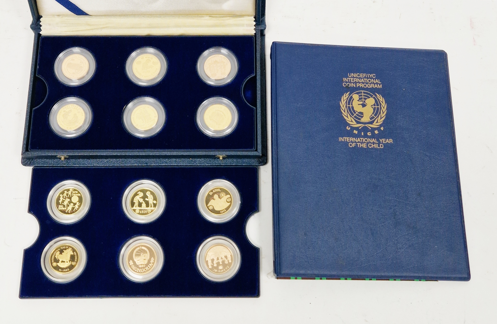Set of twelve gold coins from the Unicef/IYC International Coin Program to commemorate the