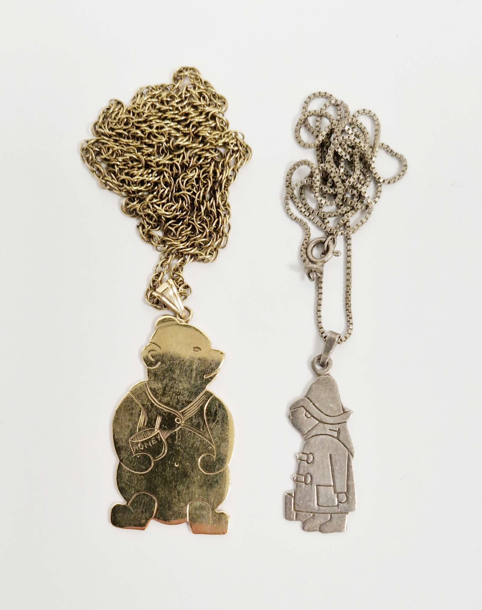 9ct gold pendant of Winnie the Pooh with a honeypot, with presentation inscription to the reverse,