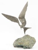 Grace Critchley, bronze effect model of a bird in flight over a rock, name plaque to rock base, 40cm