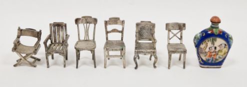 Set of six white metal menu or place name holders, each in the form of a different style of chair,