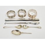 Silver napkin ring with engine-turned decoration, two further silver napkin rings, a pair of