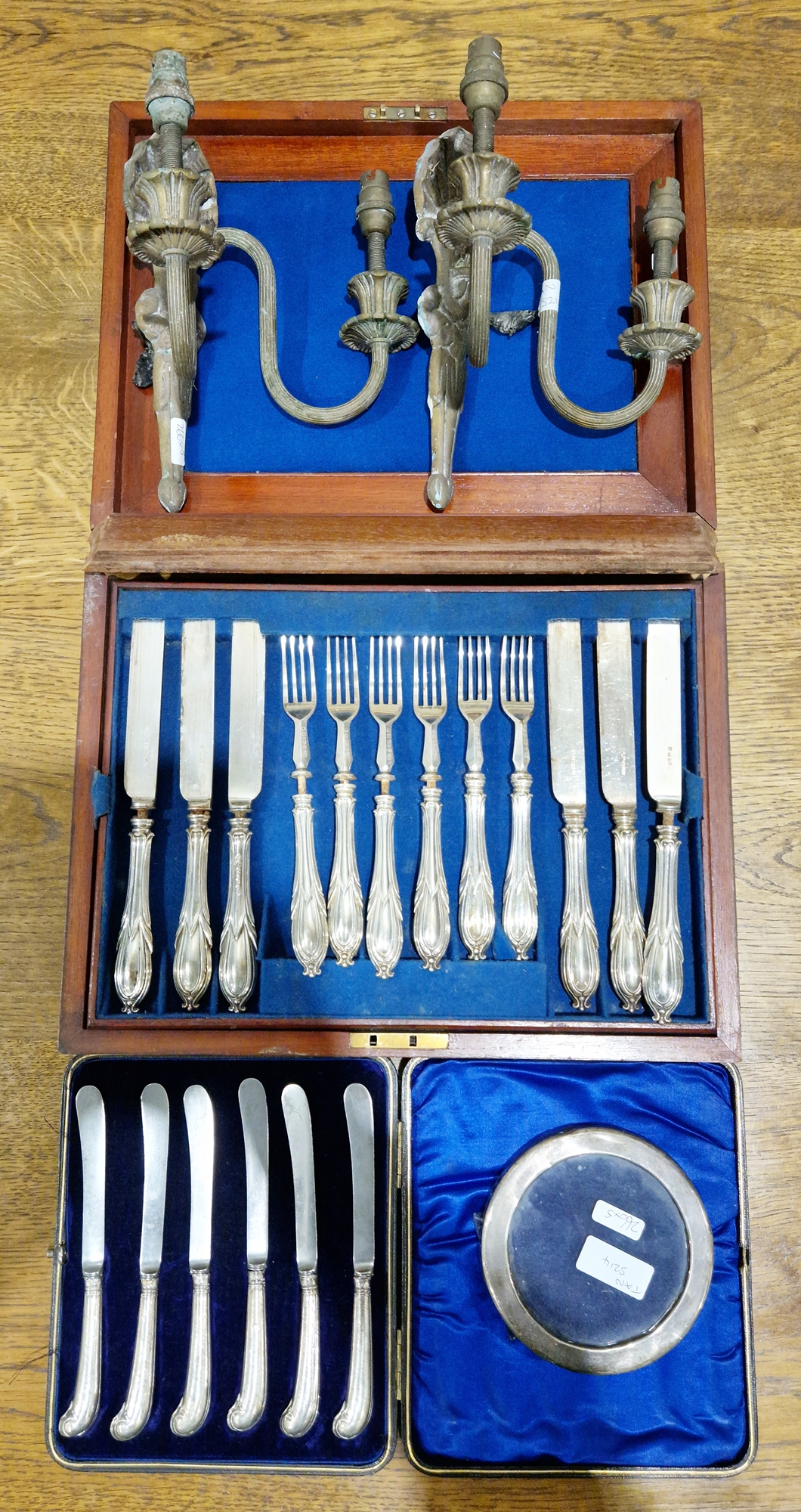 Set of six cake knives with silver pistol-grip handles in fitted case, a cased set of twelve pairs