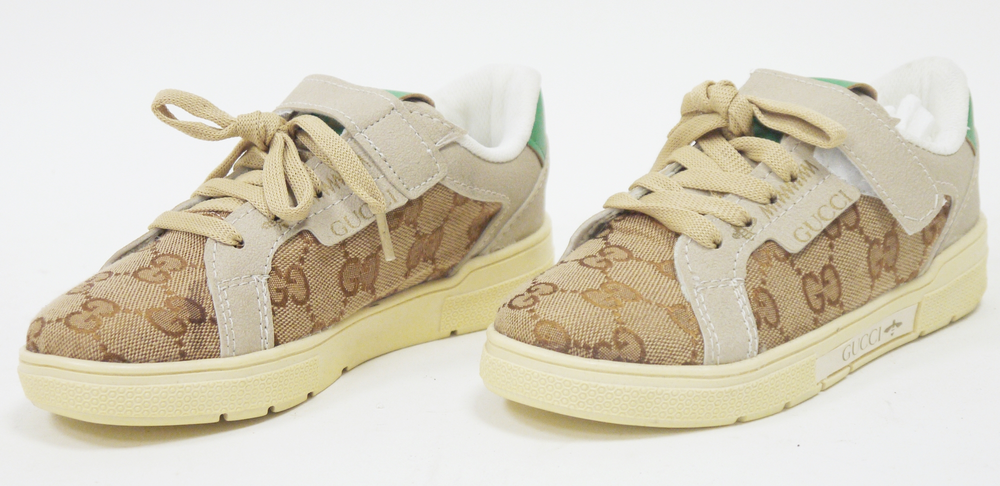 Pair of Gucci child's shoes or trainers, size 28, brown canvas printed with the GG logo, with