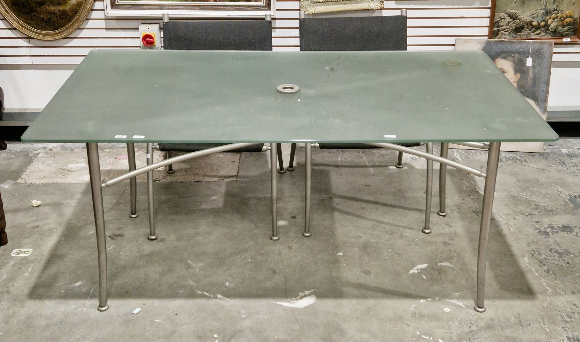 Gaze Burvill garden table, the rectangular frosted glass top on brushed steel tubular legs united by