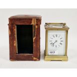 Brass cased striking carriage clock with bevelled glass panels, the white face with Roman