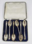 Set of six George V silver golfing spoons, each with trefoil and golf club decorated handles,