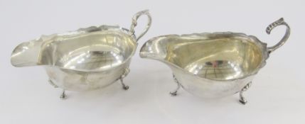 Silver sauceboat with serpentine everted rim, scroll handle, on three stepped pad feet, Birmingham