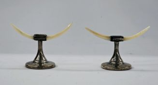 Pair silver and mother-of-pearl knife rests, each with tapering mother-of-pearl supports, on