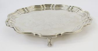 Silver salver with serpentine moulded border, on three scroll supports, London 1938, 21ozt approx