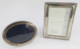 Two silver photograph frames, one oval, 17cm x 13cm approx, the other rectangular, 18.5cm x 14cm