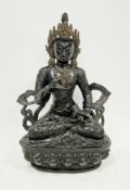 Sino-Tibetan dark brown patinated bronze figure of a boddhisatva, seated on a lotus flower wearing