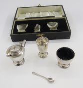 Silver cruet set viz:- salt, pepperette and mustard, all circular and tapered with turned finials,