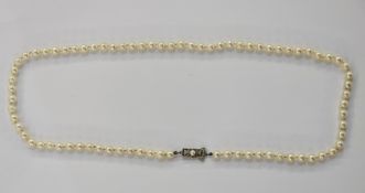 String of cultured pearls on white metal clasp, matinee length, 21