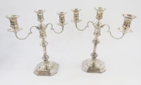Pair Elkington silver candelabra, each three-light with cylindrical sconce, circular drip tray,