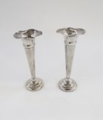 Pair George V silver spill vases, each with wavy everted rim, tapering on stepped circular foot,