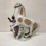 An 18th or 19th century Turquerie style porcelain figure group depicting The Sultan’s Horse and