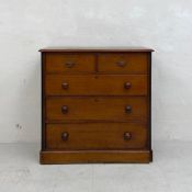 A 19th century walnut chest of two short over three long graduating drawers with turned handles