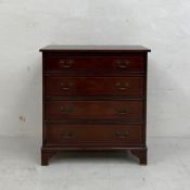 A Georgian style mahogany chest of four long graduating drawers with brass swan-neck handles