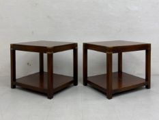 A pair of campaign style mahogany side or lamp tables each having a square brass mounted top