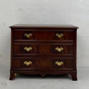 A Georgian style mahogany chest of drawers having a thumb-moulded top over three long graduating