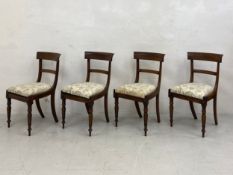 A set of four William IV rosewood bar-back dining chairs each having a curved top rail over a
