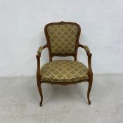 A Louis XV style carved beech framed armchair. H.86cm