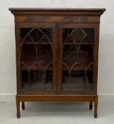 A 19th century mahogany bookcase with astragal glazed doors on square tapering supports.