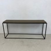 A contemporary metal framed console table with granite slab top. 69x160x37cm