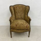 A 19th century Louis XVI style wing armchair with painted beech frame newly upholstered in foliate