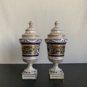 A pair of 19th century Dresden porcelain urns each having a cup and cover finial and semi lobed