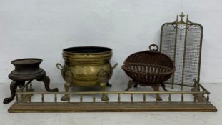 A 19th century brass fire-kerb, folding fire-screen, and large brass log bin with a cast iron fire