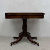A Regency mahogany card table with foldover top revealing a baize playing surface raised on a