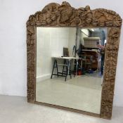 A 19th century carved oak overmantel mirror with cherub and eagle carved cresting with the