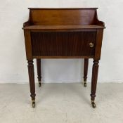 A small George IV mahogany side cabinet with lift up top above tambour door raised on tapering