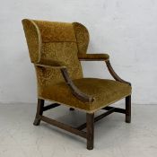 A George III carved mahogany framed wing back library armchairin cut foliate upholstery. H.99cm