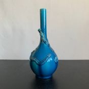 A possibly 19th century turquoise glazed Chinese bottle vase decorated with coiled figural dragon