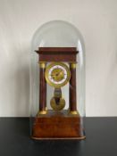 A 20th century gilt metal mounted French Empire style mahogany portico clock having a moulded