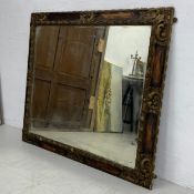 A late 19th century carved and painted wall mirror with scrolling foliate detail. H.87 W.99cm