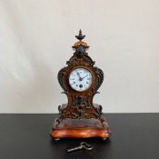 A 20th century gilt metal mounted French style walnut Lenzkirch mantle clock with urn finial and