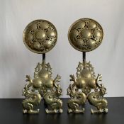A large pair of 19th century andirons or fire dogs each with a pierced brass flowerhead surmount