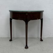 An early Georgian red walnut demi-lune side table with lift up top on slender cabriole pad foot