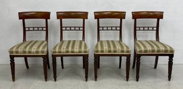 A set of four early 19th century bar back dining chairs with stuffover seats on tapering reeded