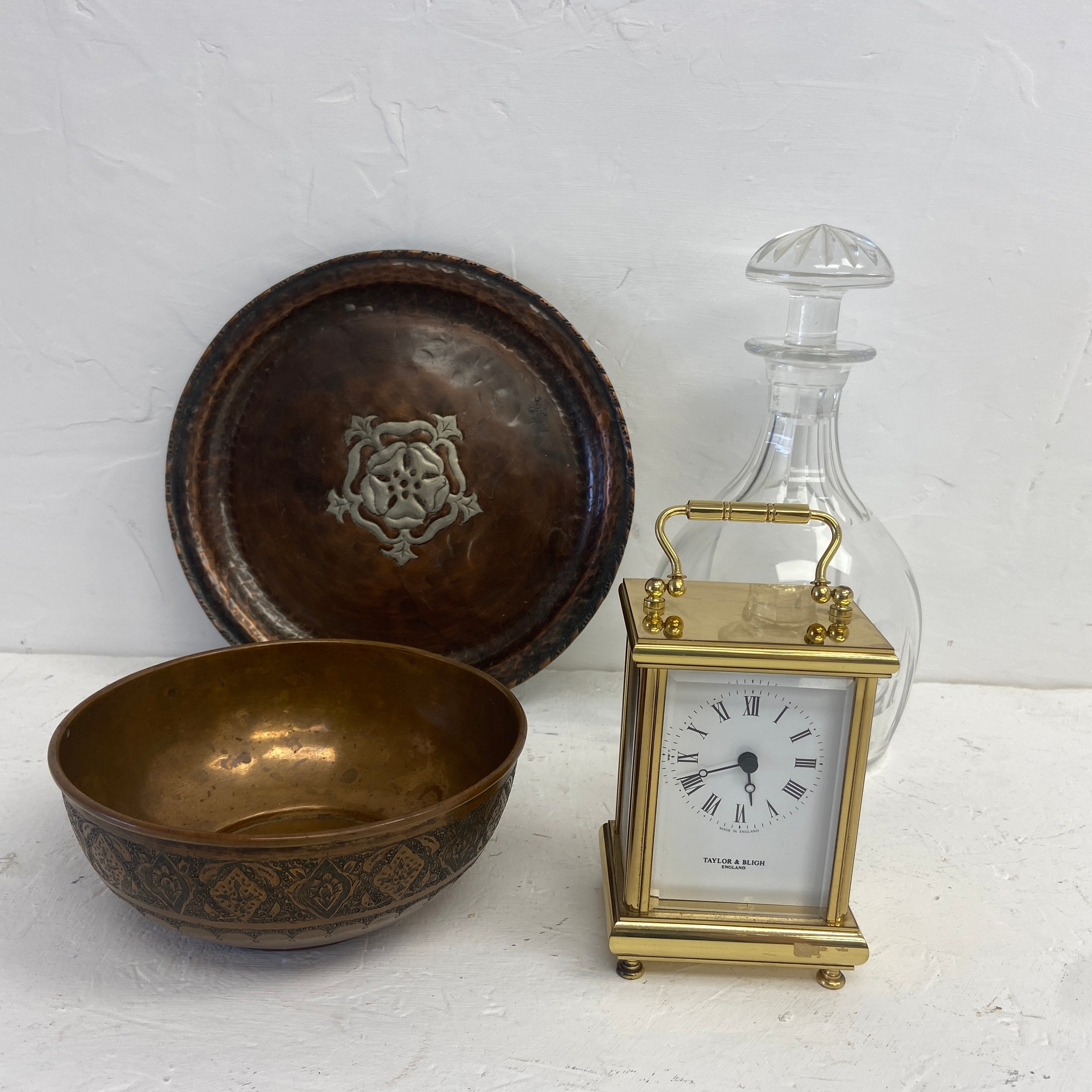 An Arts and Crafts copper tray with inset white metal rose motif, an Eastern brass bowl, a
